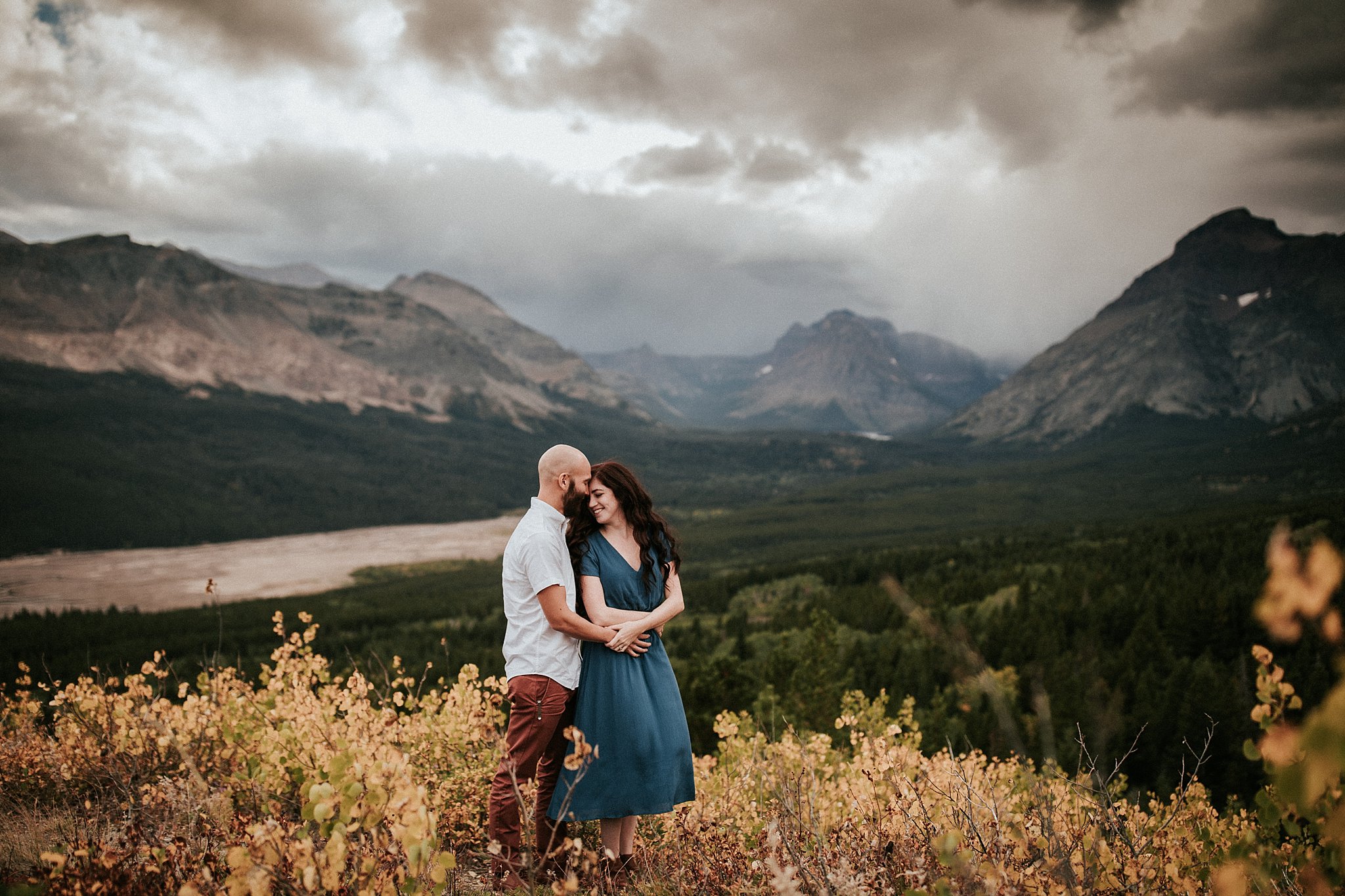 couple holding each other in the mountains