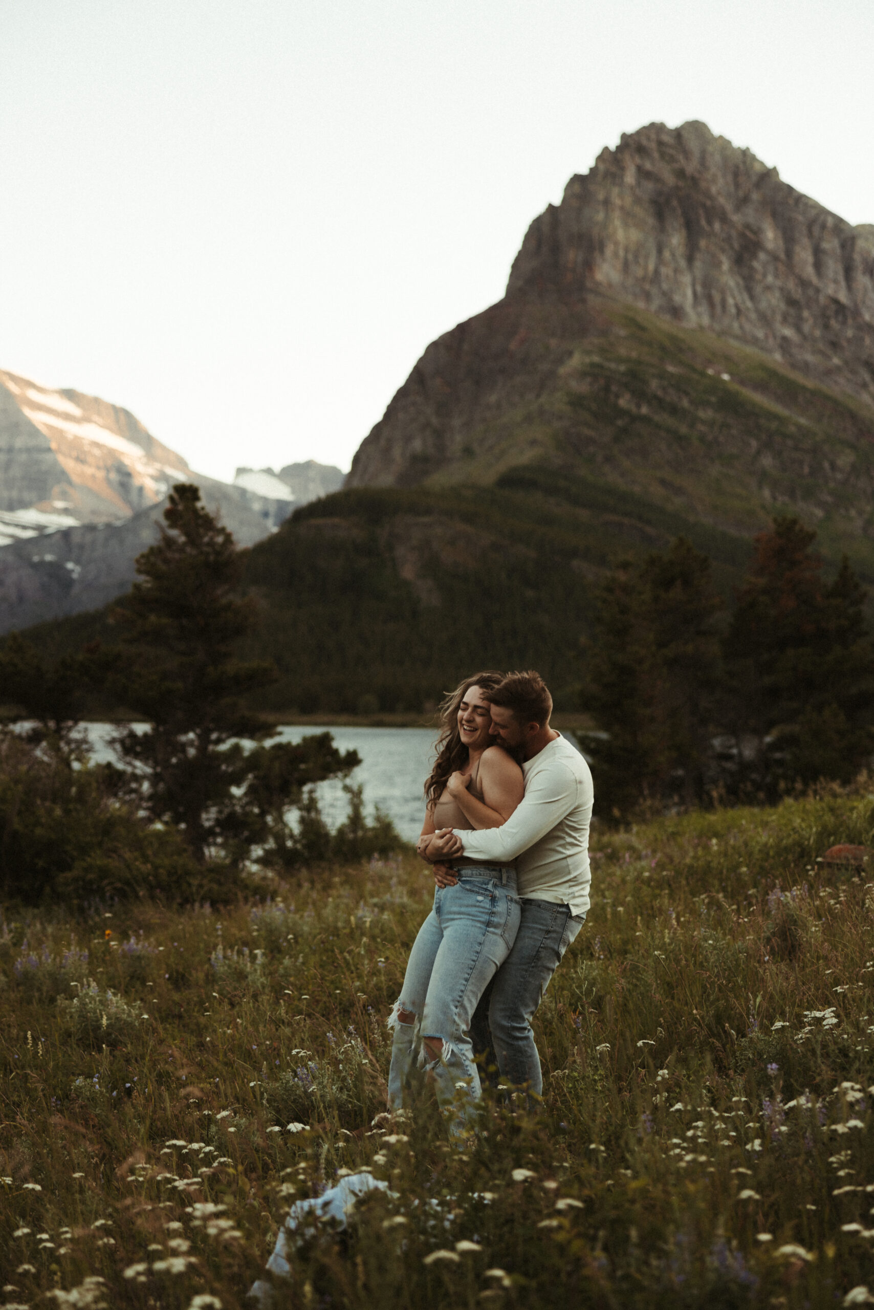 vintage couples photoshoot by the lake with mountains behind